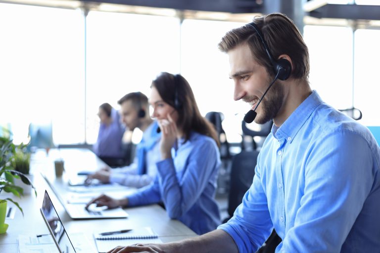 A smiling male call center operator