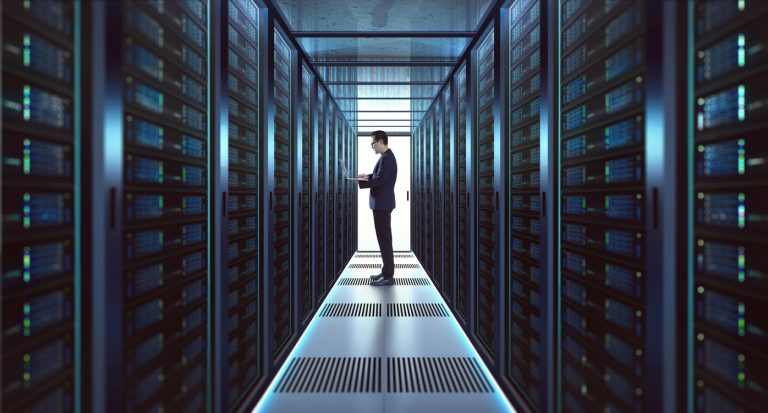 IT Technician in suit works on laptop