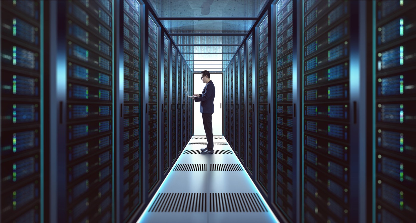 IT Technician in suit works on laptop