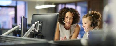 A female call centre worker trains an intern.