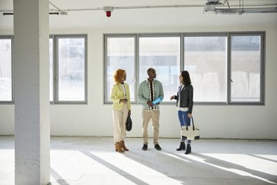 Businesswomen in 20s and 30s Discussing Property with Broker