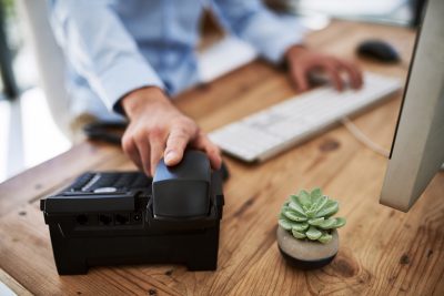 An employee holding a telephone