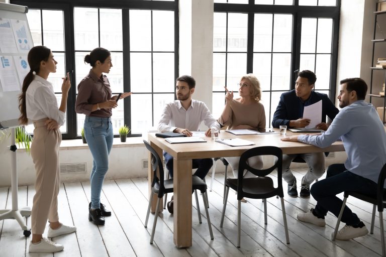 A group of employees talking to each other