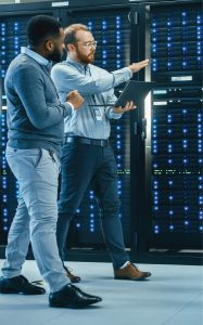 Two IT employees walking in a data server room