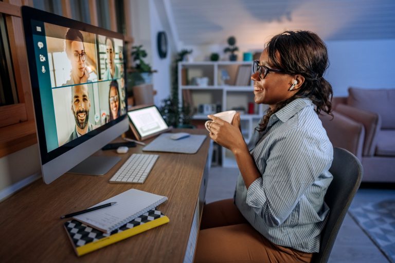 An employee smiling at her computer