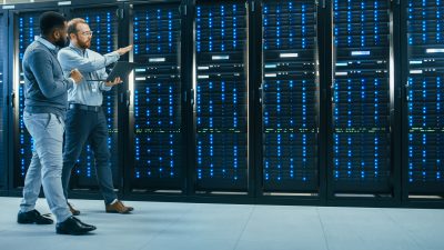 Two engineers walking in a server room