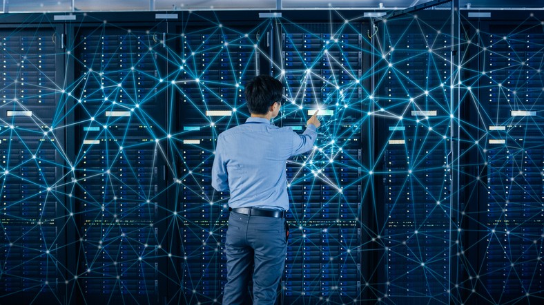 An IT engineer standing in a server room