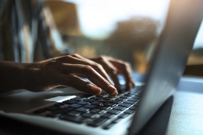 A person typing on a laptop