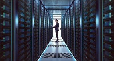 An IT employee working in a data server room