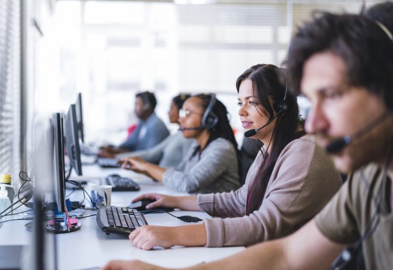 A group of employees wearing headsets