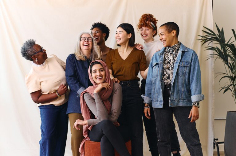 Portrait of cheerful mixed age range multi ethnic women celebrating International Women’s Day